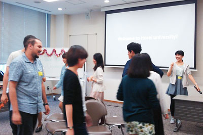 A scene of a welcome reception held by the Faculty of Intercultural Communication: the reception warmed up with musical chairs