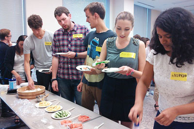 Exchange students eating hand-rolled sushi for the first time at the welcome reception held by the Faculty of Intercultural Communication:Caution - Wasabi (Japanese horseradish) is very hot!