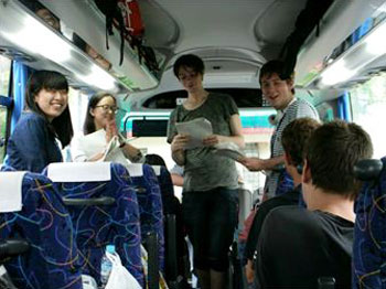Students presented outlines of the sites they were scheduled to visit by group in the bus.