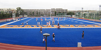 Players training on the bright colored ground dedicated to the Hosei Football team