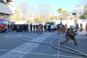 消防訓練の様子を見学する学生たち
